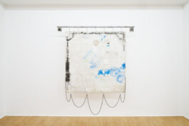 Edoardo Caimi's artwork Cloak + 40% enhanced defense, 2019, made of spray paint, chain, snap hooks, hooks, plastic bottle and iron on fabric, 207 × 230 × 30 cm Installation view of last exhibition at the gallery