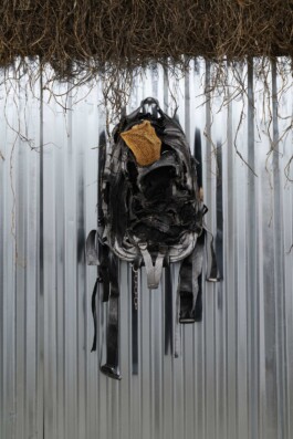Edoardo Caimi'artwork, Liver for leaving, 2019, made of burnt backpack, dried cow's liver, chain, clay, wood and straw, sheet, 102 × 46 × 19 cm Installation view of last exhibition at the gallery