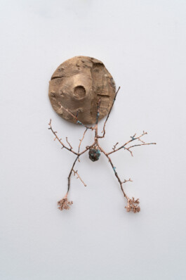 Figli di Horo, 2024 Bronze, copper and silver 43 × 15 × 8 cm. The artwork consists of four circular plaques mounted on a white wall, each adorned with organic, branch-like elements protruding from them. The plaques seem to be made of a material resembling clay or plaster, with intricate details and textures that give them a natural, earthy feel. The branches attached to each plaque vary in form and complexity, adding a dynamic and somewhat fragile appearance to the overall installation. Installation view of last exhibition at the gallery